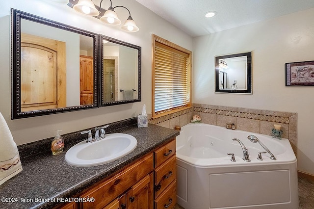full bath with a whirlpool tub and vanity