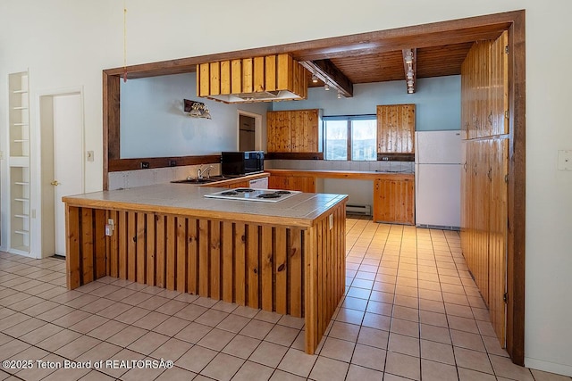 kitchen with wooden ceiling, white appliances, a peninsula, beam ceiling, and light tile patterned flooring