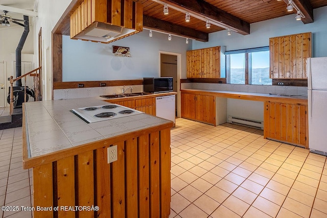 kitchen featuring a baseboard radiator, rail lighting, tile counters, and white appliances