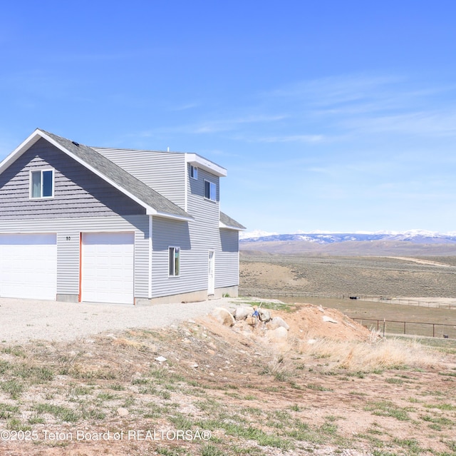 50 Shriver Ln, Pinedale, WY 82941 - view of property exterior with a mountain view and a garage