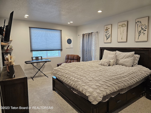 carpeted bedroom featuring baseboards, recessed lighting, and a textured ceiling