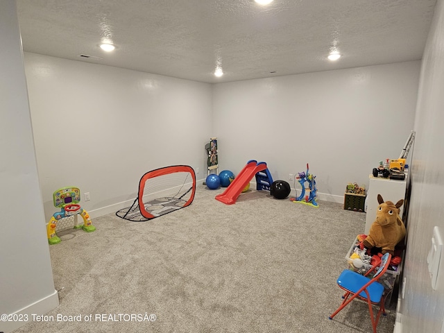 playroom featuring carpet floors, baseboards, and visible vents