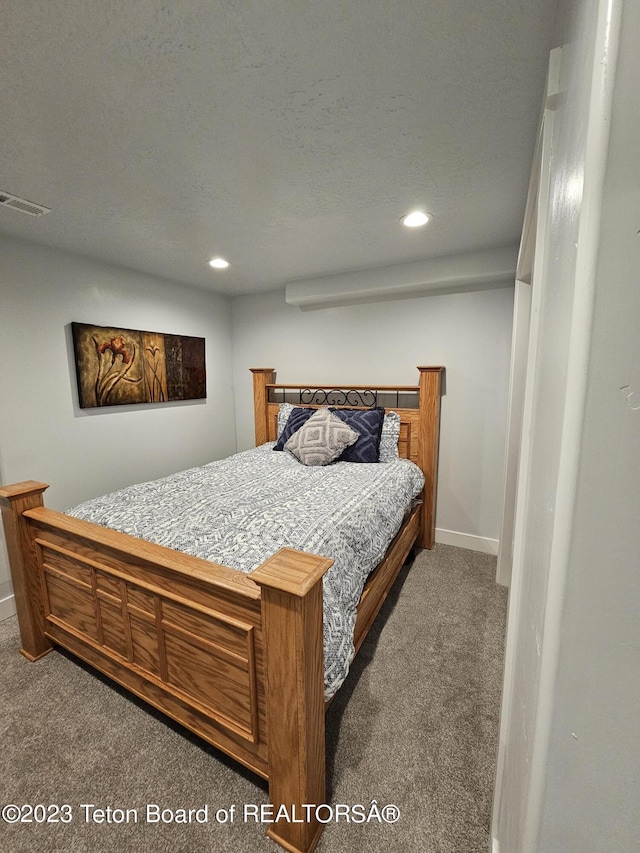carpeted bedroom featuring baseboards, visible vents, and recessed lighting