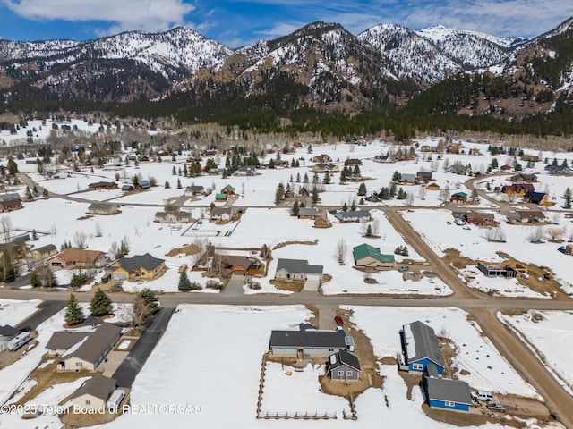 snowy aerial view with a mountain view