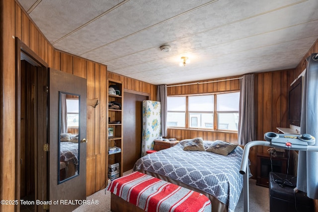 44 12th St, Marbleton, WY 83113 - bedroom featuring wooden walls, a closet, and carpet flooring
