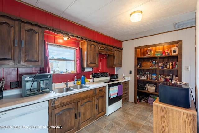44 12th St, Marbleton, WY 83113 - kitchen featuring light countertops, wooden walls, a sink, and white appliances