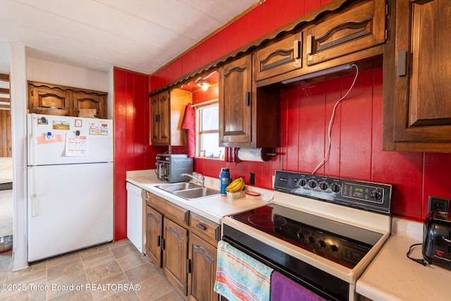 44 12th St, Marbleton, WY 83113 - kitchen featuring a sink, light countertops, and white appliances