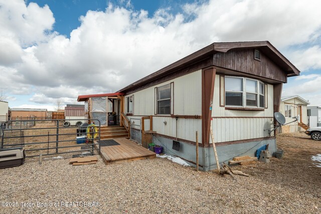 44 12th St, Marbleton, WY 83113 - view of side of home with a deck and fence