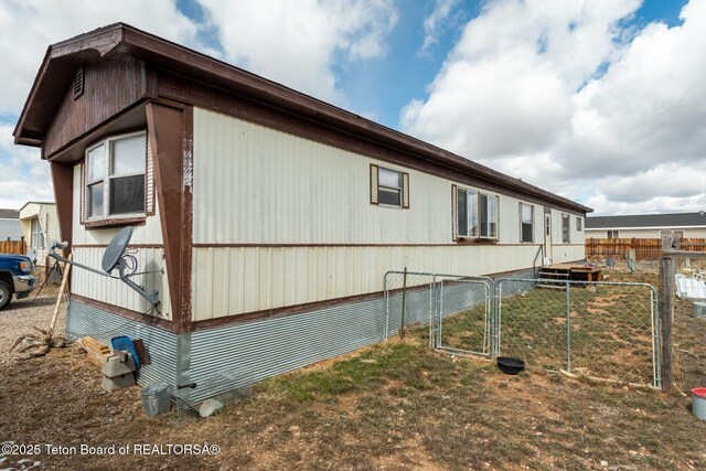 44 12th St, Marbleton, WY 83113 - view of home's exterior with fence and a gate