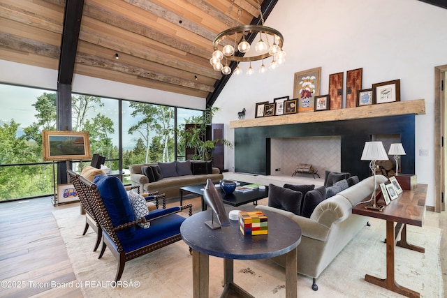 1165 W Bar Bc Ranch Rd, Jackson, WY 83001 - living area featuring high vaulted ceiling, a chandelier, wood finished floors, a wooden ceiling with exposed beams, and a fireplace with raised hearth