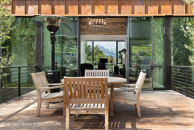 1165 W Bar Bc Ranch Rd, Jackson, WY 83001 - sunroom / solarium with a mountain view and a chandelier