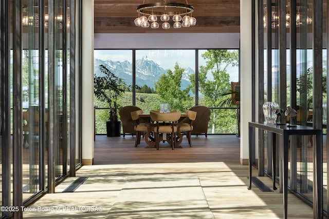 1165 W Bar Bc Ranch Rd, Jackson, WY 83001 - dining area with a mountain view, a chandelier, and wood finished floors