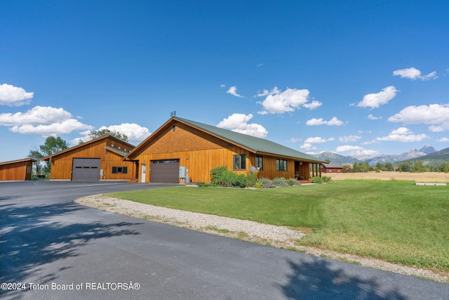 1820 Fall Line Dr, Driggs, ID 83422 - view of front facade with a detached garage, a mountain view, and a front yard