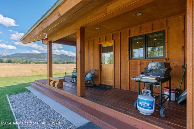 1820 Fall Line Dr, Driggs, ID 83422 - wooden deck featuring a yard, a mountain view, and covered porch