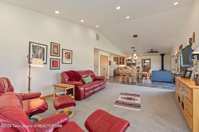 1820 Fall Line Dr, Driggs, ID 83422 - living room with visible vents, a wood stove, high vaulted ceiling, and carpet