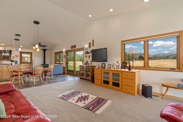 1820 Fall Line Dr, Driggs, ID 83422 - living room with a wood stove, high vaulted ceiling, recessed lighting, light carpet, and baseboards