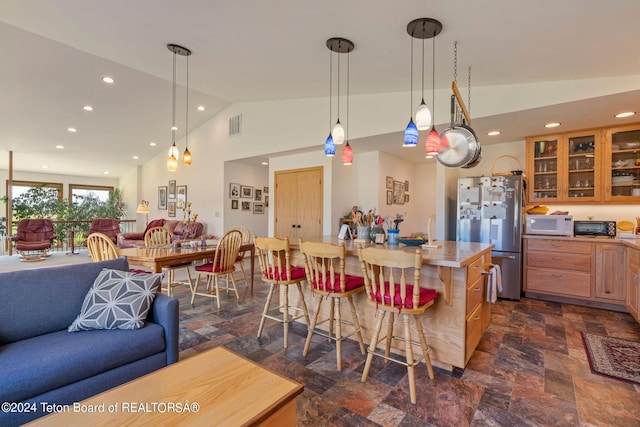 1820 Fall Line Dr, Driggs, ID 83422 - kitchen featuring open floor plan, white microwave, freestanding refrigerator, and a breakfast bar area