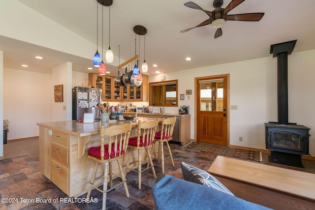1820 Fall Line Dr, Driggs, ID 83422 - kitchen featuring a kitchen island, stone finish floor, a breakfast bar, and appliances with stainless steel finishes