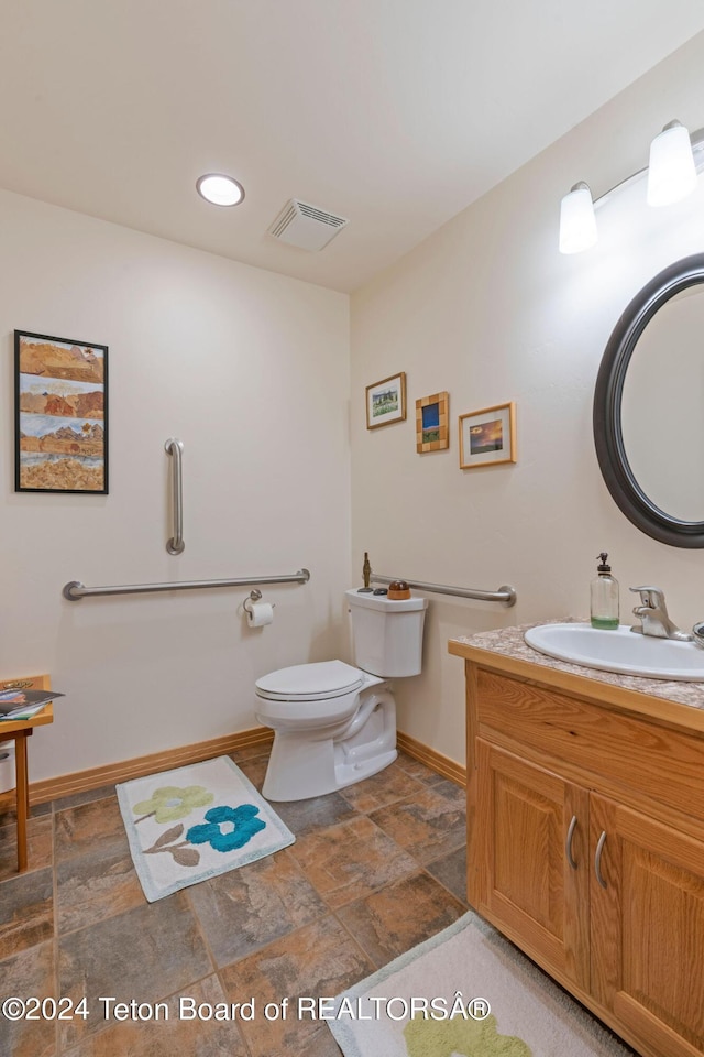 1820 Fall Line Dr, Driggs, ID 83422 - bathroom with vanity, baseboards, toilet, stone finish floor, and visible vents