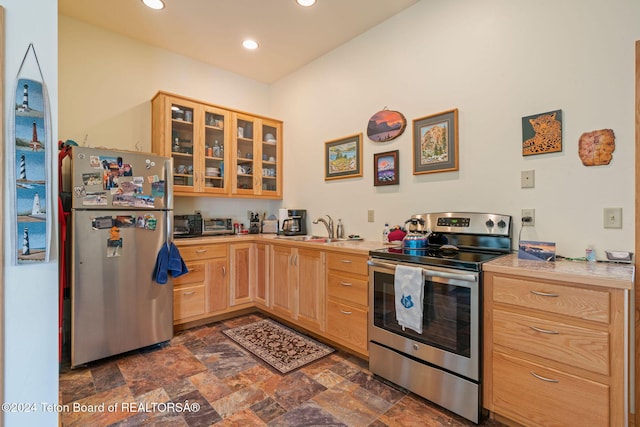 1820 Fall Line Dr, Driggs, ID 83422 - kitchen with light countertops, appliances with stainless steel finishes, a sink, and light brown cabinetry