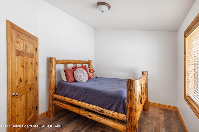 bedroom with baseboards and wood finished floors
