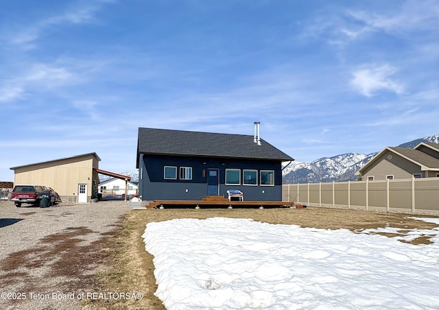 exterior space featuring a mountain view and fence
