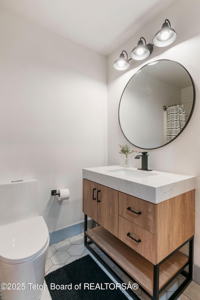 2032 Dandelion Ct, Jackson, WY 83001 - bathroom featuring vanity, toilet, and tile patterned flooring