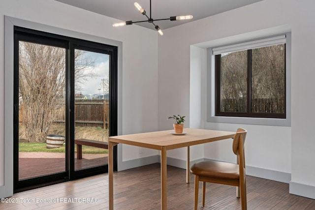 2032 Dandelion Ct, Jackson, WY 83001 - dining space featuring a chandelier, plenty of natural light, wood finished floors, and baseboards