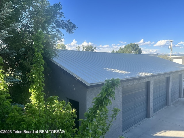 17 C B Ln, Pinedale, WY 82941 - view of side of property with stucco siding, metal roof, and a garage