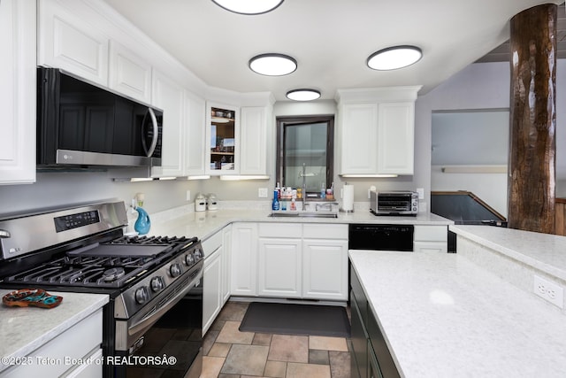 17 C B Ln, Pinedale, WY 82941 - kitchen featuring stainless steel gas stove, white cabinets, light countertops, and glass insert cabinets