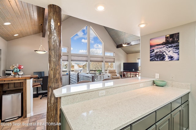 17 C B Ln, Pinedale, WY 82941 - kitchen featuring green cabinetry, fridge, open floor plan, a peninsula, and high vaulted ceiling