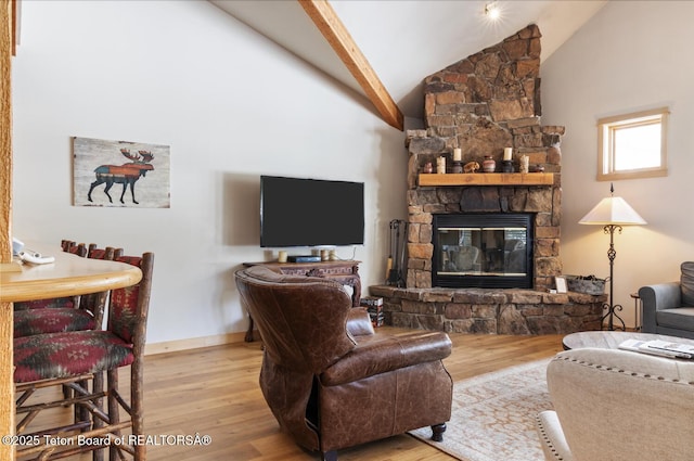 3723 W Michael Dr Unit 13, Teton Village, WY 83025 - living room featuring baseboards, wood finished floors, high vaulted ceiling, and a stone fireplace