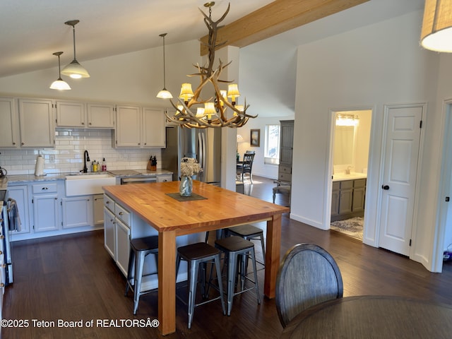 3048 Rangeview Dr, Jackson, WY 83001 - kitchen featuring stainless steel fridge, a chandelier, wood counters, dark wood finished floors, and a sink