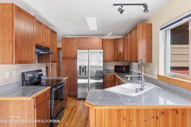 708 Palisades Ln, Alpine, WY 83128 - kitchen featuring stainless steel refrigerator with ice dispenser, a sink, under cabinet range hood, tile counters, and double oven range