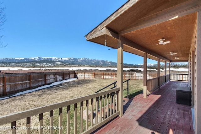 708 Palisades Ln, Alpine, WY 83128 - wooden terrace with a fenced backyard, a mountain view, and a ceiling fan