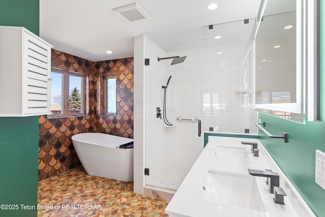 708 Palisades Ln, Alpine, WY 83128 - bathroom with a sink, visible vents, a shower stall, and a freestanding tub