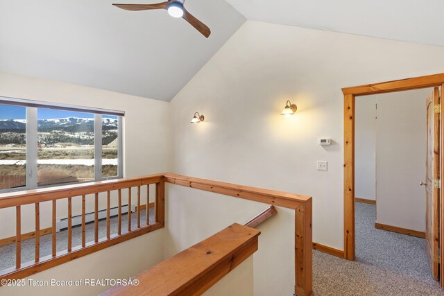 708 Palisades Ln, Alpine, WY 83128 - hallway featuring baseboard heating, baseboards, vaulted ceiling, and carpet floors