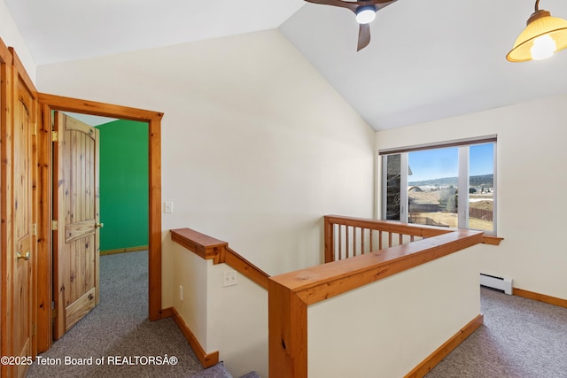 708 Palisades Ln, Alpine, WY 83128 - corridor featuring vaulted ceiling, carpet floors, baseboard heating, an upstairs landing, and baseboards