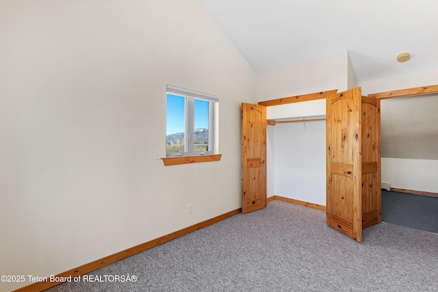 708 Palisades Ln, Alpine, WY 83128 - unfurnished bedroom with a closet, baseboards, high vaulted ceiling, and carpet flooring