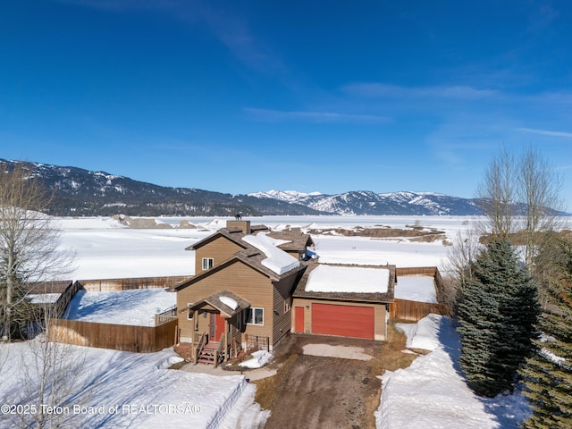 708 Palisades Ln, Alpine, WY 83128 - exterior space with a mountain view, fence, and dirt driveway