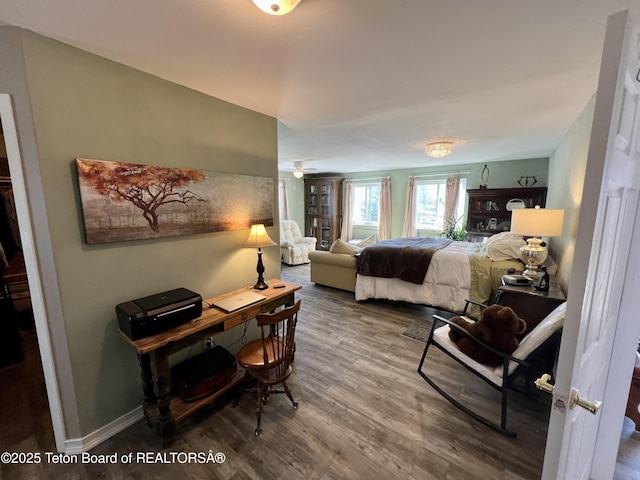 bedroom featuring baseboards and wood finished floors