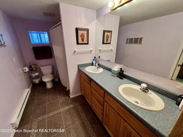 bathroom featuring baseboard heating, tile patterned floors, a sink, and toilet