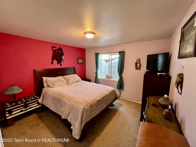 bedroom featuring carpet floors and a textured ceiling