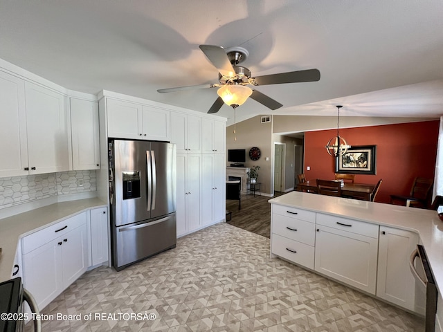 kitchen with a peninsula, light countertops, white cabinetry, a ceiling fan, and appliances with stainless steel finishes