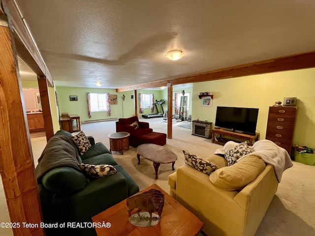 living room with baseboard heating, light colored carpet, and a textured ceiling