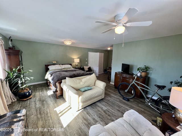 bedroom featuring baseboards, a ceiling fan, and wood finished floors