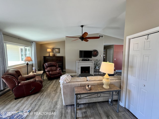 living room featuring visible vents, a ceiling fan, wood finished floors, and lofted ceiling