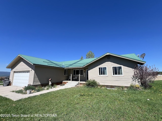 341 Alta, Star Valley Ranch, WY 83127 - single story home with a front yard, metal roof, covered porch, and an attached garage