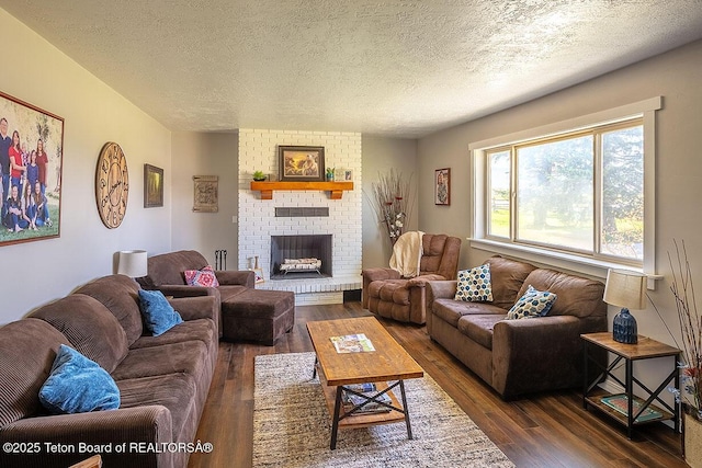 102295 US Highway 89, Thayne, WY 83127 - living area featuring dark wood-style floors, a textured ceiling, and a brick fireplace