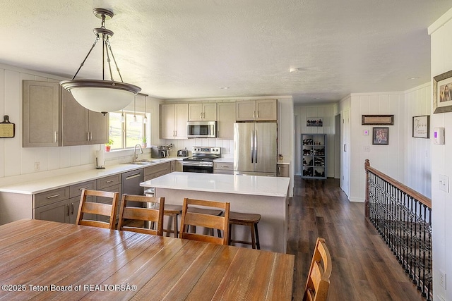 102295 US Highway 89, Thayne, WY 83127 - kitchen featuring stainless steel appliances, a sink, gray cabinets, dark wood-style floors, and light countertops